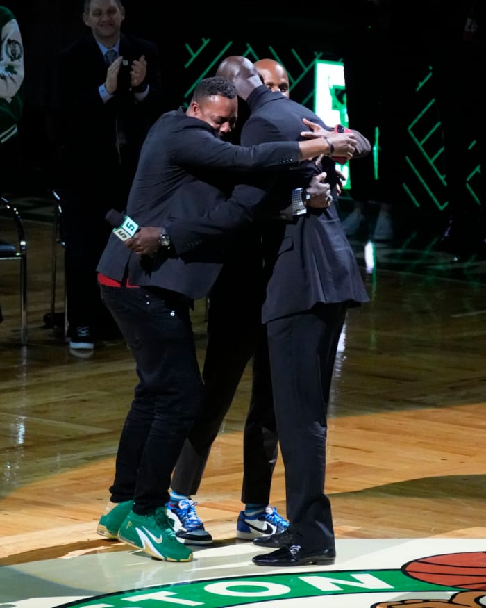 Basketball Hall of Famer and former Boston Celtic, Kevin Garnett embraces former Boston Celtics players, Ray Allan and Paul Pierce during the number retirement ceremony after the game between the Boston Celtics the Dallas Mavericks at TD Garden.